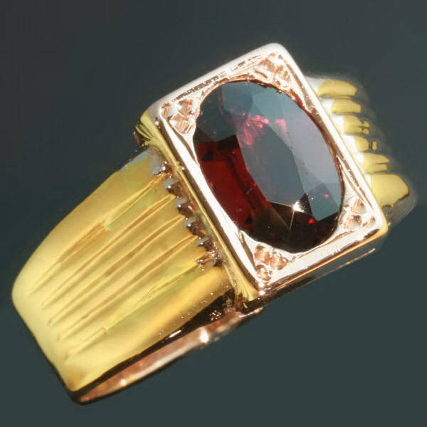 Gold Victorian ring set with garnet and with hidden space that can be closed