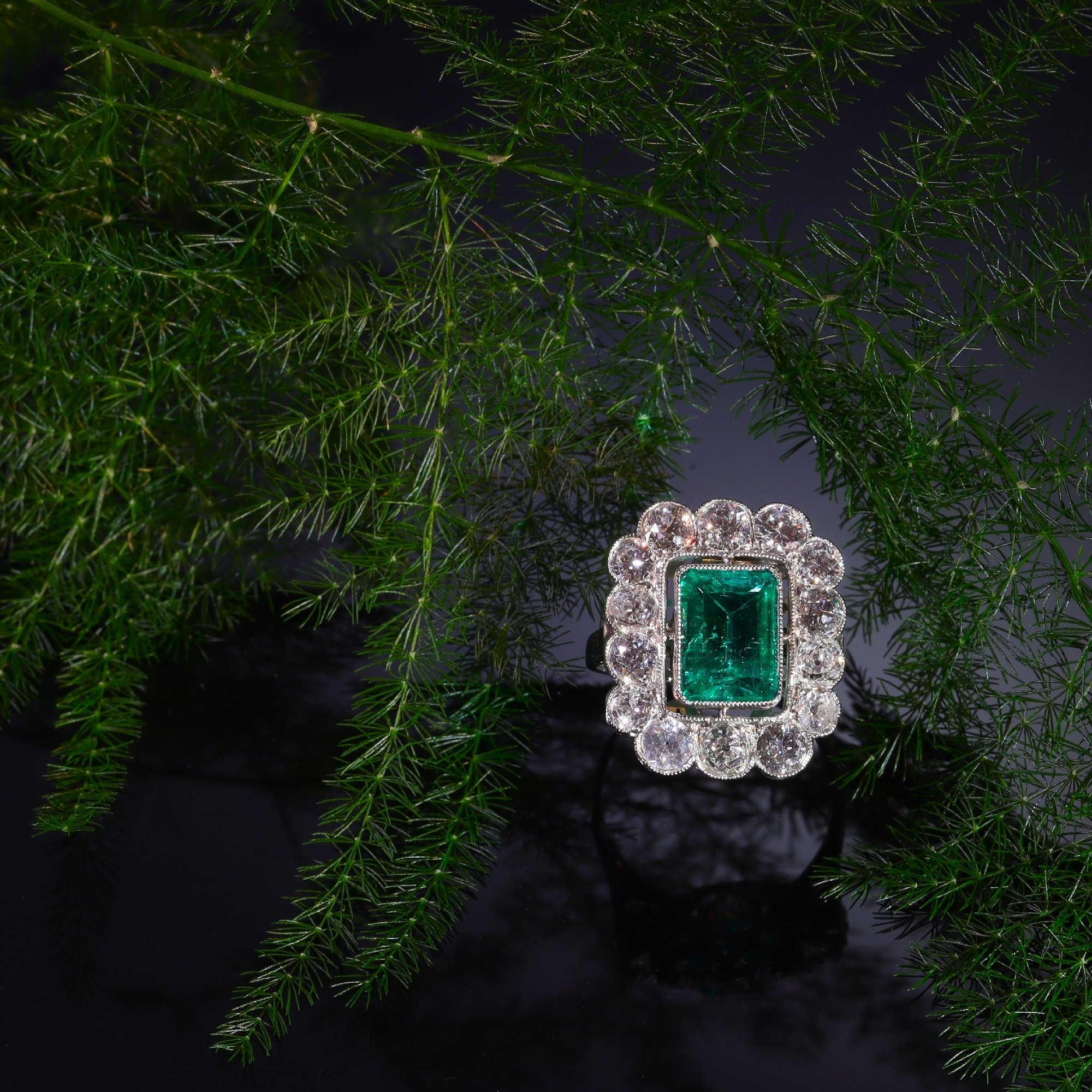 Click the picture to see more of this Vintage Fifties platinum diamond ring with untreated natural emerald