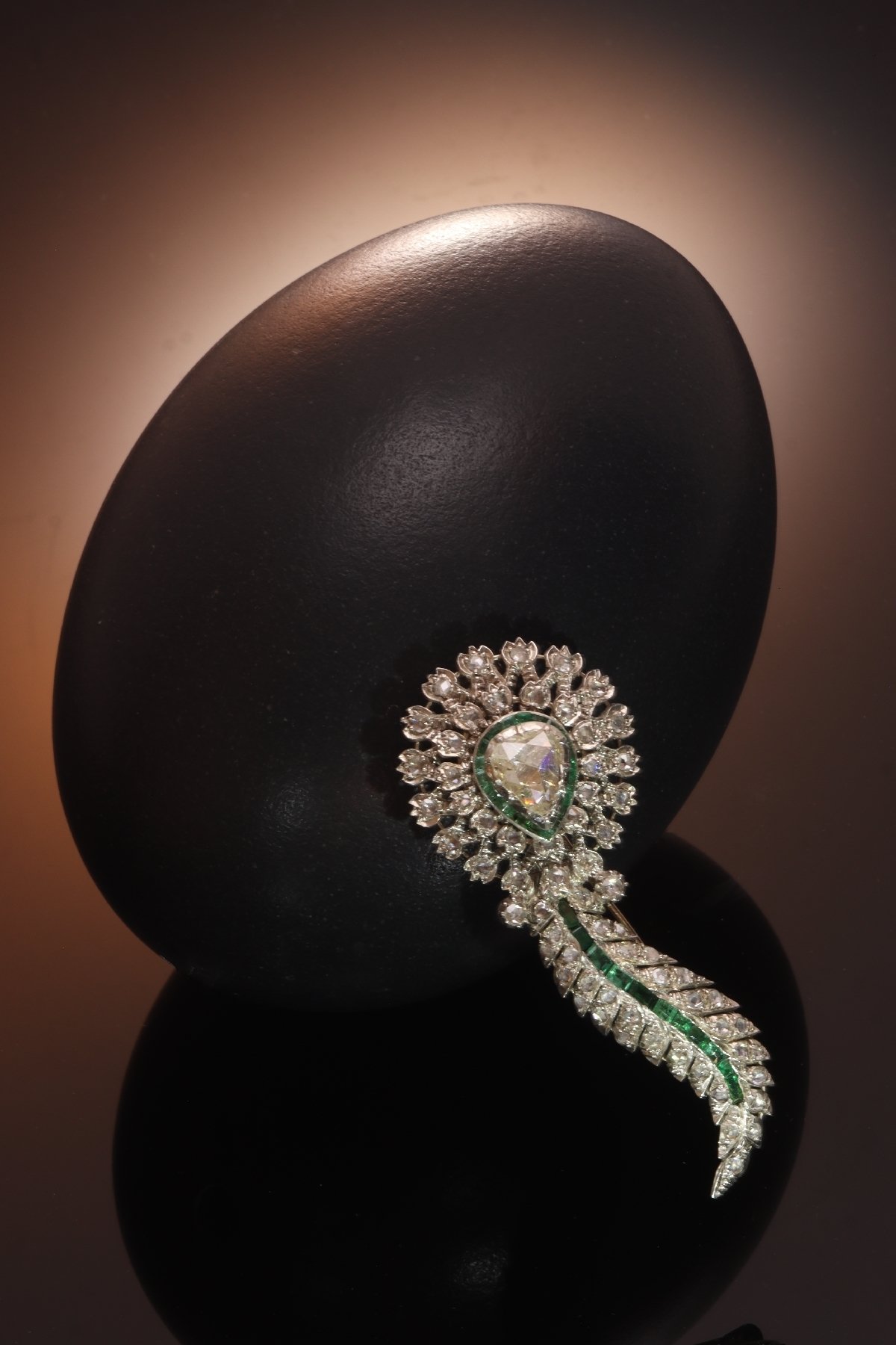 Click the picture to find out more about this antique brooch with large pear shaped rose cut diamond and set with many rose cut diamonds and carre cut emeralds