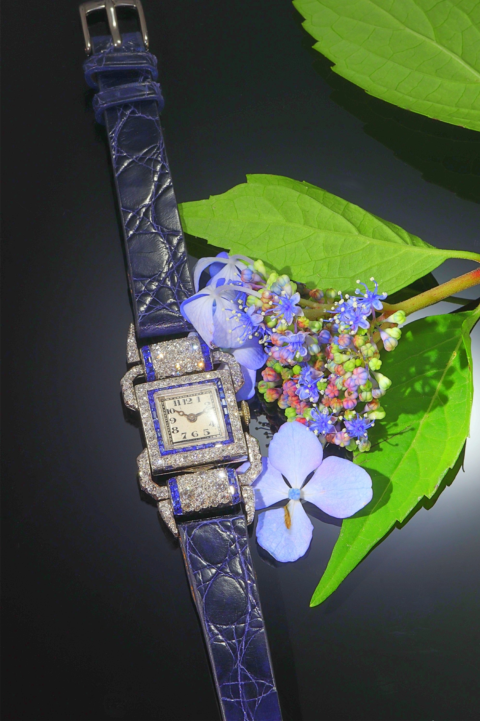 Click the picture to see of this Vintage Art Deco platinum ladies wrist watch made by Leon Hatot set with diamonds and sapphires