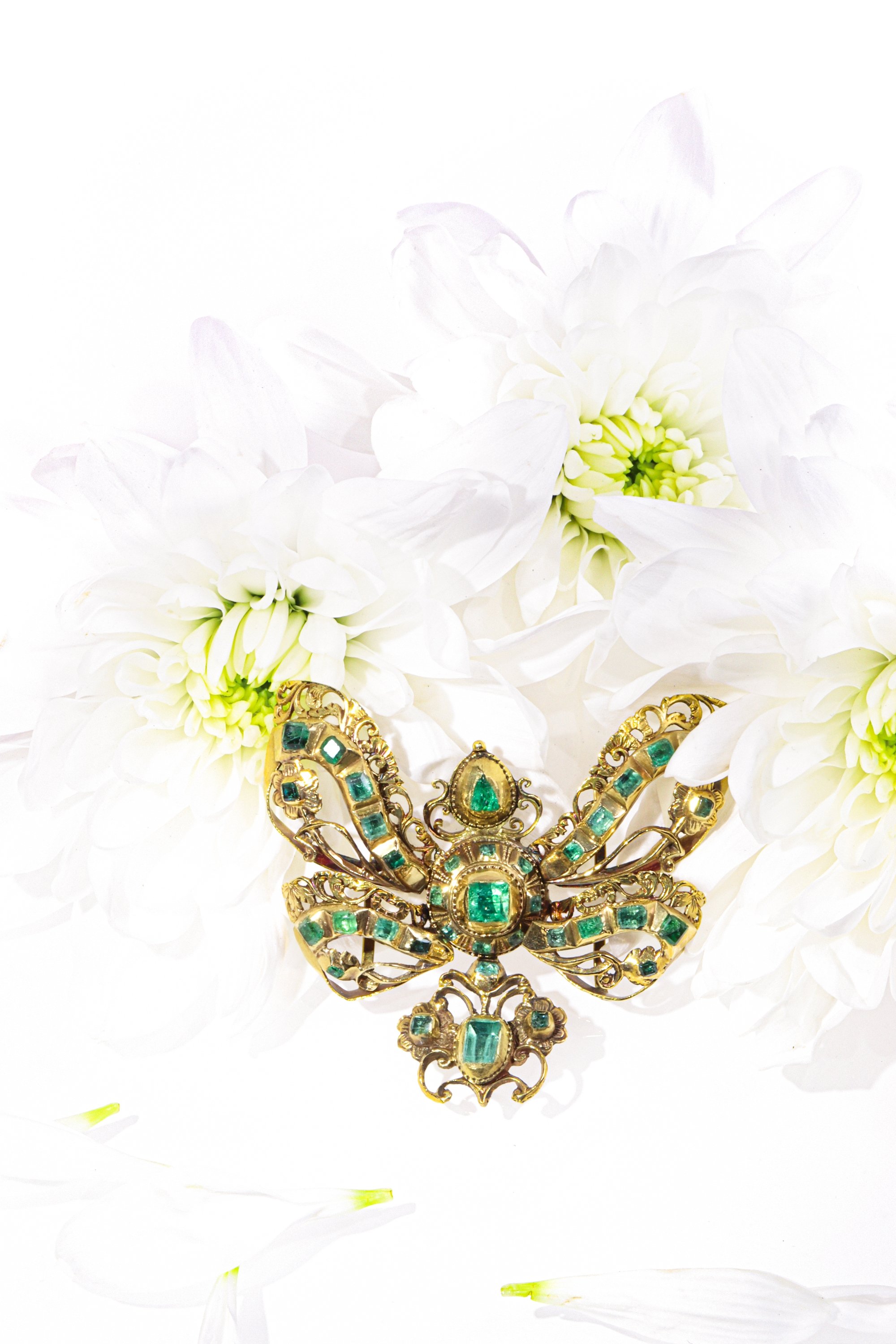 Click the picture to find out more about this Museum-Exhibited Emerald Bow Pendant, Circa 1650  Baroque Elegance in Gold